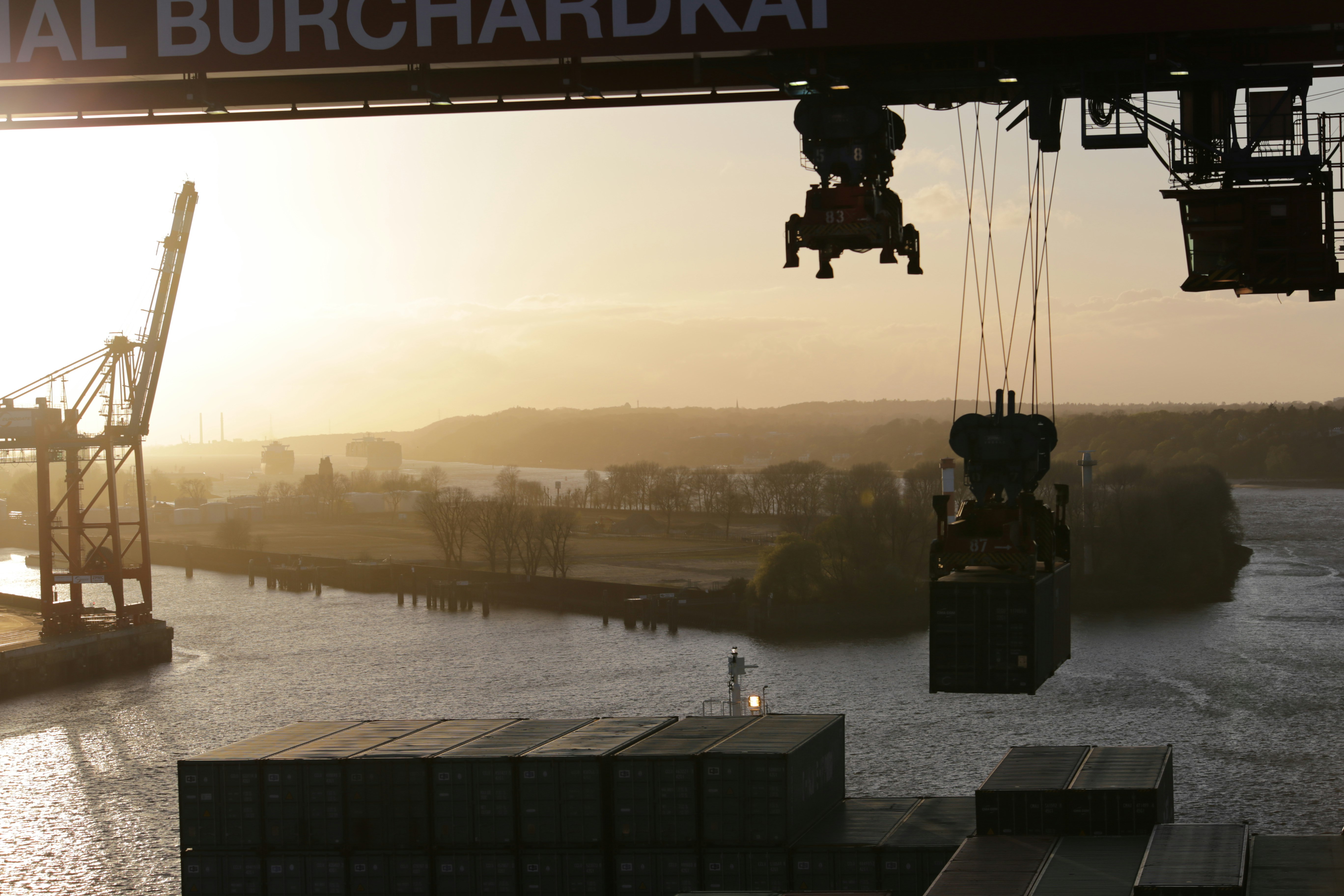 silhouette of man standing on dock during sunset